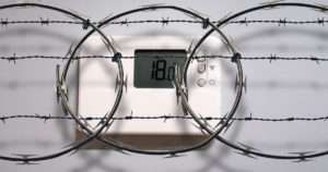 Thermostat covered by barbed wire