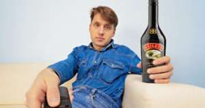 man with a bottle of baileys