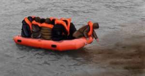 migrants in small boats following the turds