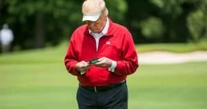 Donald Trump on the golf course with a pager