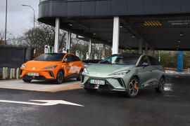 mg 4 xpower drives past an mg 4 extended range in a car park