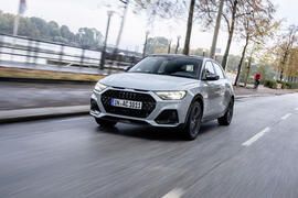 Grey Audi A1 driving down a city street