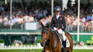 Ros Canter smiles as she walks Lordships Graffalo out of the Defender Burghley Horse Trials dressage arena on a long rein after a test that leaves her in second place to her other ride.