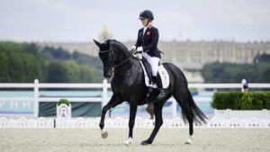 Sophie Wells riding LJT Egebjerggards Samoa in the Paralympics freestyle with the Palace of Versailles in the background