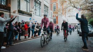 Tom March and Ian Stark lead the Cycle4Caroline riders across the finish at the Savoy Hotel, London.