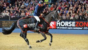 John Whitaker riding Argento to win the Santa Stakes at Olympia Horse Show