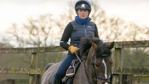 Pippa Funnel rides with no stirrups and a stick behind her back to help keep elbows back.