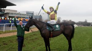 Paul Townend and groom Adam Connolly salute the crowd with their Irish Gold Cup winner Galopin Des Champs