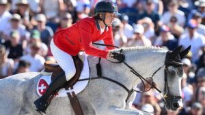 Martin Fuchs jumping at the Paris Olympics.