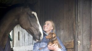 Georgie Campbell looks adoring at her horse while holding her dog Twig in her arms. The foundation prize draw aims to raise money for a programme set up in Georgie’s memory.