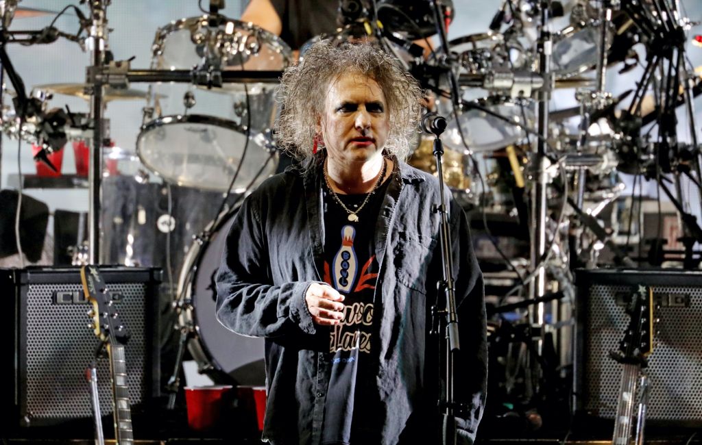 Robert Smith performing live on stage with The Cure