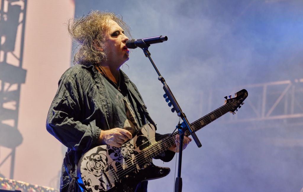 Robert Smith performing live on stage with The Cure