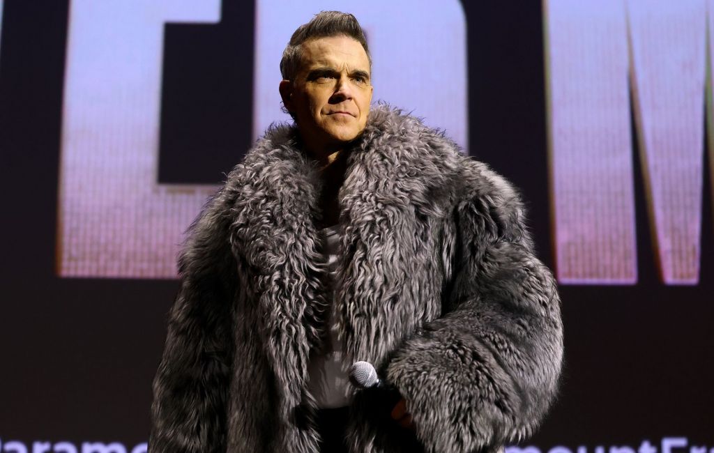 Robbie Williams speaks on stage during the "Better Man" special screening, December 2024