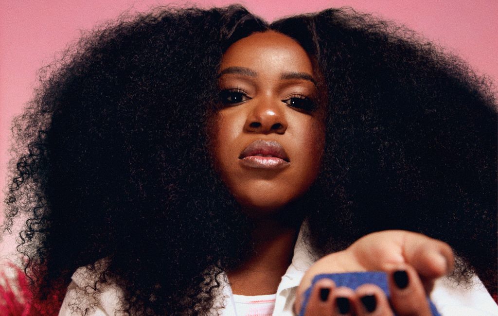 Nao photographed holding blue sand in her hand, photo by Lillie Eiger