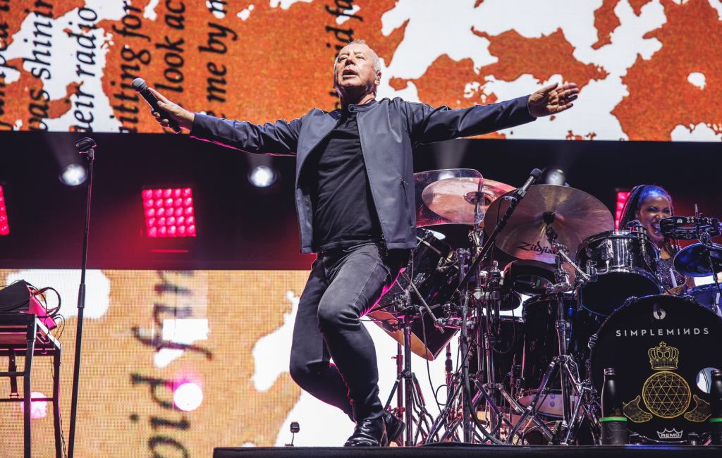 Jim Kerr performing live on stage with Simple Minds