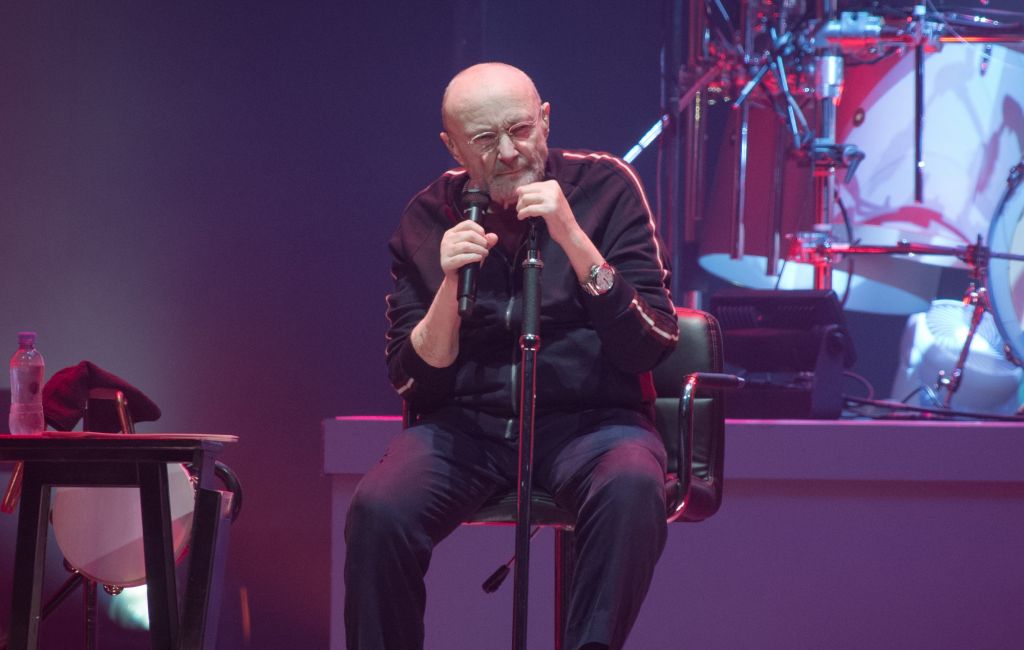 Phil Collins performing live on stage