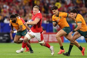 Wales' Jac Morgan runs with the ball as Australia players give chase in the teams' World Cup 2023 match.