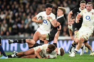 England's Marcus Smith tries to evade a tackle from New Zealand's Damian McKenzie during the first test in July 2024.