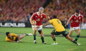 The Lions' Jonathan Davies holds off Australia's Joe Tomane during the Sydney test match in 2013.