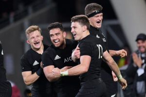 New Zealand's Beauden Barrett celebrates a try with teammates Damian McKenzie , Anton Lienert-Brown and Scott Barrett