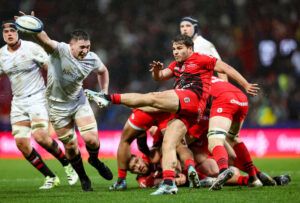 Antoine Dupont of Toulouse executes a box kick during his team's December 2024 European Champions Cup match against Ulster