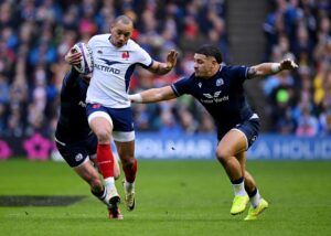 France's Gael Fickou runs with the ball while Scotland's Sione Tuipulotu attempts to make a tackle during the 2024 Six Nations.