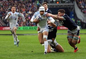 Italy’s Simone Gesi attempts to evade a tackle from Scotland players in the February 2025 Six Nations match