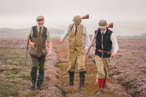 Three well-dressed guns on the moor