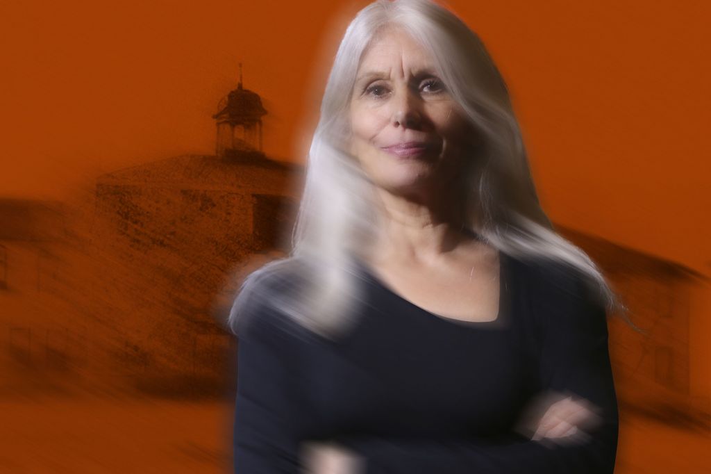 In a photo illustration, Jani Lauzon appears, slightly blurred, against an orange background with a building