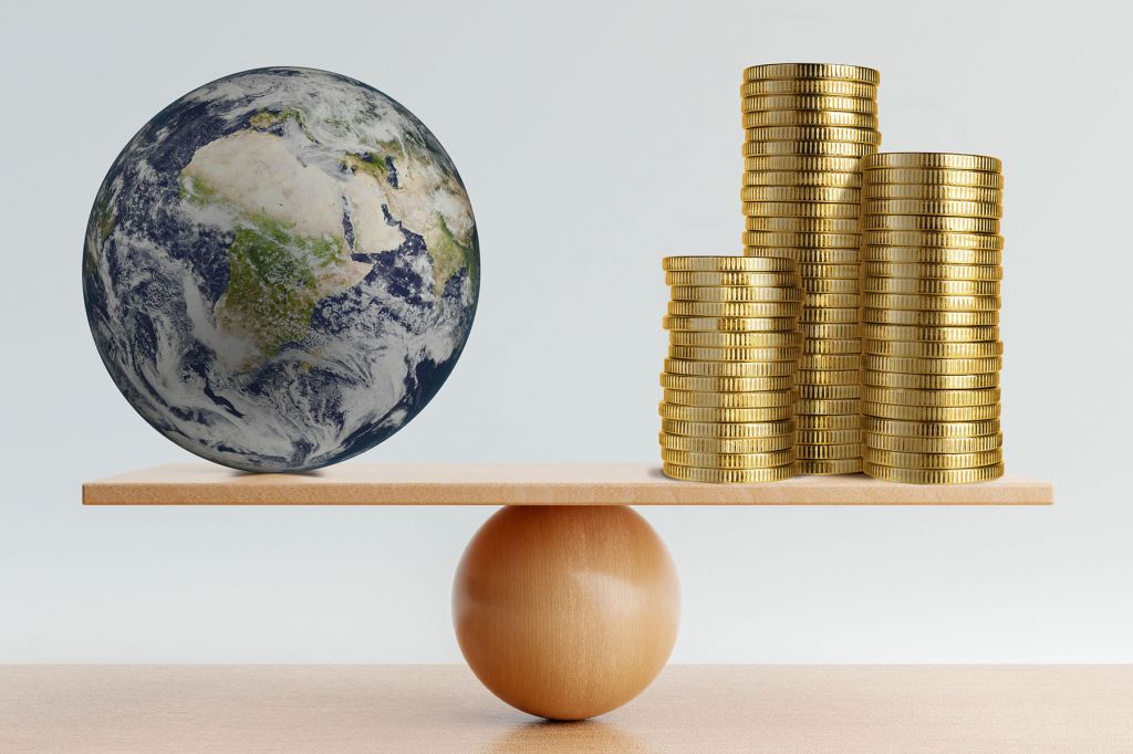 A globe balancing with a stack of coins