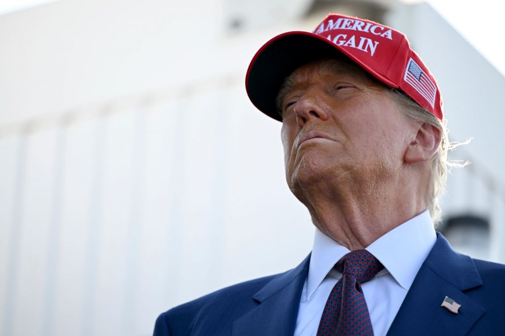 A close up photo of Donald Trump wearing a read MAGA cap