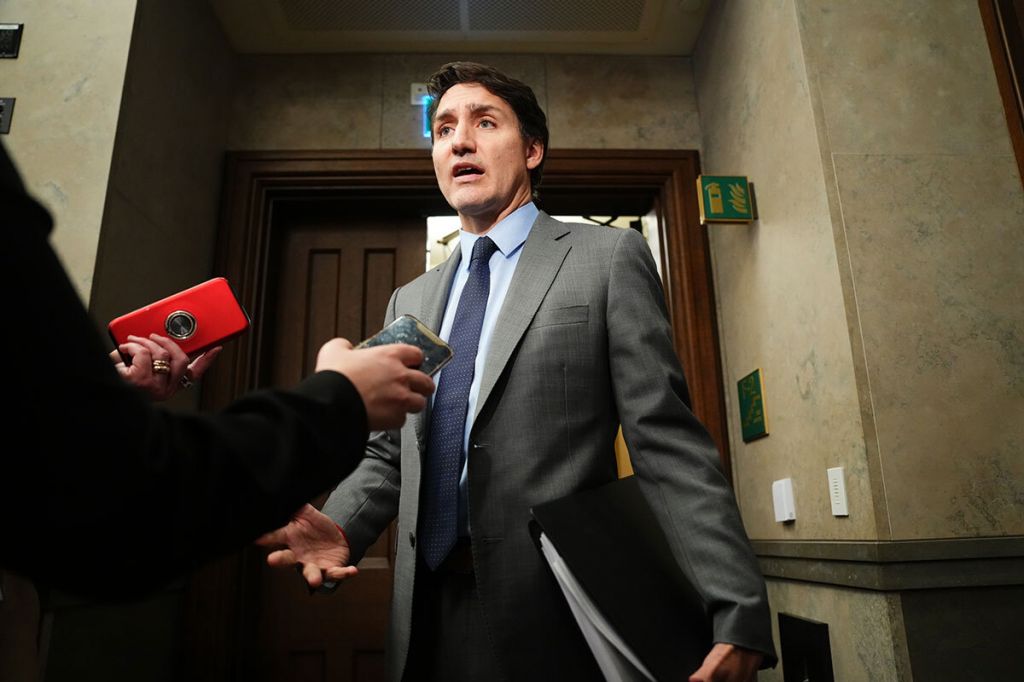 Prime Minister Justin Trudeau talks to media in the foyer outside the House of Commons prior to Question Period in Ottawa on Wednesday, Dec.4, 2024.