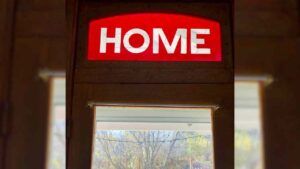 The word "home" hangs over a doorway.