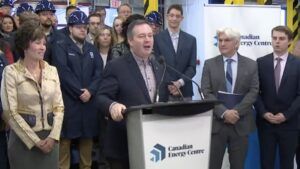 Then Alberta premier Jason Kenney touts Canadian Energy Centre Ltd. at the “Alberta Energy War Room’s” opening news conference on Dec. 11, 2019. Sonya Savage, the energy minister at the time, and CEC Ltd. CEO Tom Olsen flank the premier. The visible logo on the podium soon had to be dumped, as it belonged to another company.