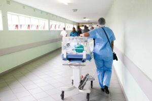 A nurse walking the hallway of a hospital.