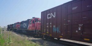 A CN train travelling down tracks.