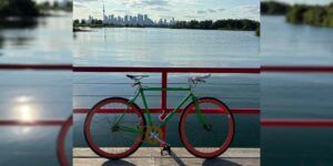 A bicycle with the Toronto skyline in the background.