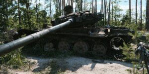 A destroyed tank in a Ukrainian forest.