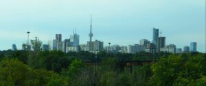 The greenery of the Don Valley Parkway in front of Toronto's skyline.