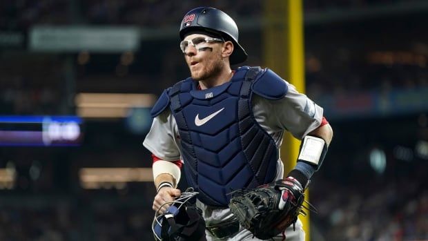 A baseball player runs onto the field.