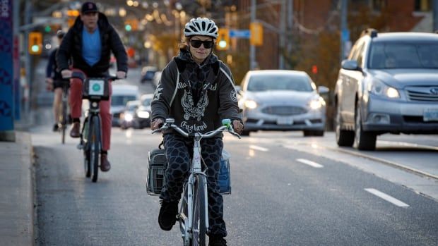 Cyclists are seen on the move in Toronto in November 2021.