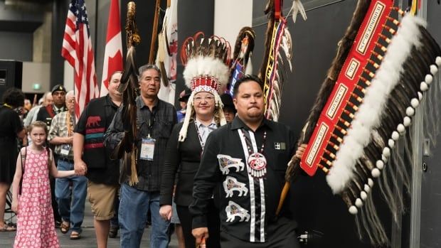 National Chief Cindy Woodhouse Nepinak, second right, walks during the grand entry at the Assembly of First Nations annual general assembly in Montreal, Tuesday, July 9, 2024. 