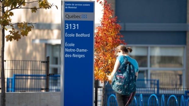 A person in front of a school