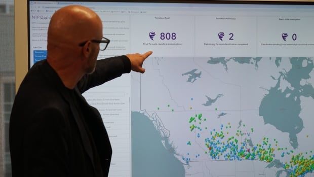 Greg Kopp reviews data on a tornado map compiled by the Northern Tornadoes Project.