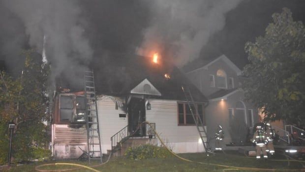 Ottawa firefighters extinguishing arson at Rossland Avenue bungalow