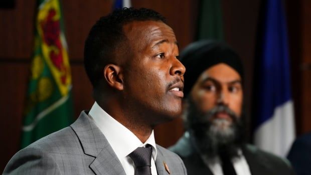 NDP leader Jagmeet Singh, right, looks on as he joins Nicholas Marcus Thompson, CEO of the Black Class Action Secretariat to hold a press conference on Parliament Hill in Ottawa on Wednesday, Sept. 28, 2022. 