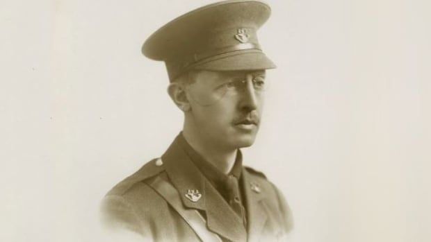 A sepia-toned image of a man wearing a military uniform. 