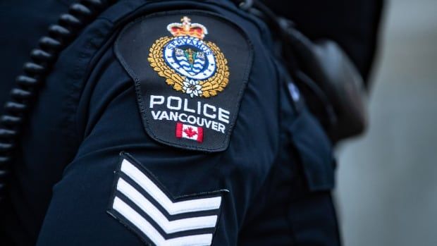 An up-close picture of a Vancouver Police Department shoulder badge with three stripes below it, signifying the rank of sergeant.