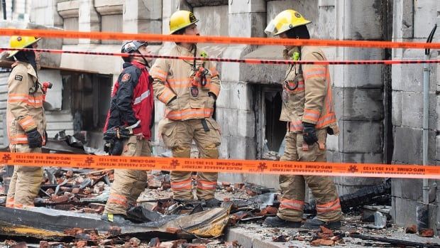 Firefighters in front of building