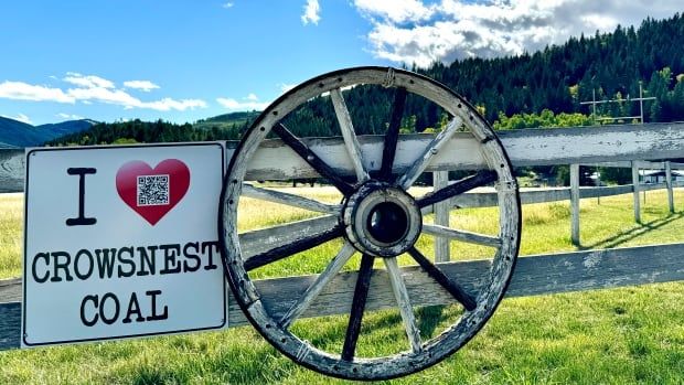 A sign is attached to a rural fence showing support for Crowsnest coal.